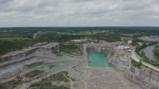 Drone flies over a quarry in the Midwestern USA.  in Summer, in 4K.