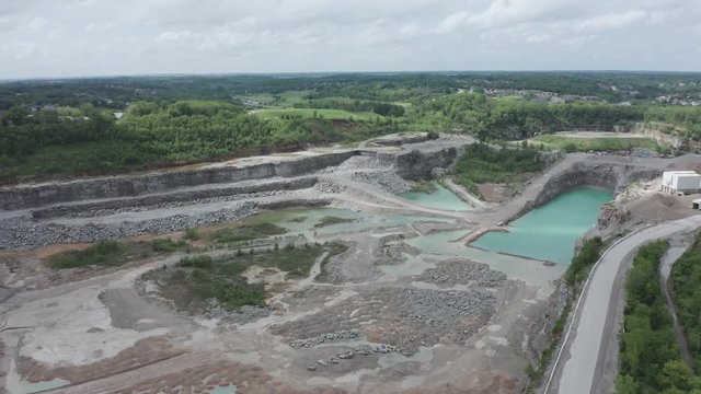 Drone flies over a quarry in the Midwest USA.  in summer, in 4k.
