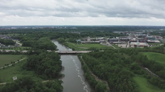 Drone flies over a river toward a highway in the Midwestern USA.  in summer, in 4K.