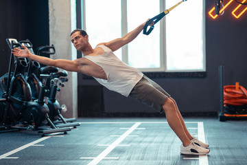 Nice good looking man doing body resistance exercises