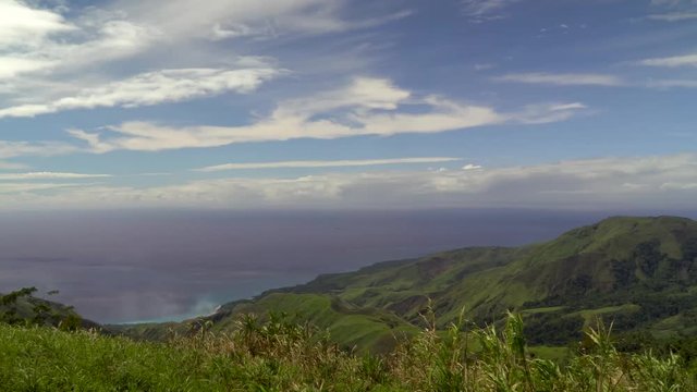 Panoramic panning view of ocean and green mountains, Morobe Province