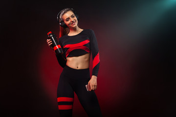 Sporty fit woman, athlete with dumbbells makes fitness exercising on red background. Fitness and workour motivation.