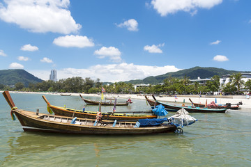 Phuket, Thailand, Patong Beach, 04/19/2019: looking over the sea towards a mainland with fishing boat in foreground.