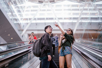 Portrait of a young, attractive and diverse Asian couple going for a holiday. A Korean man and his...