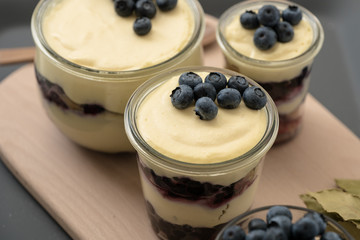 blueberry tiramisu in glasses on wooden tray