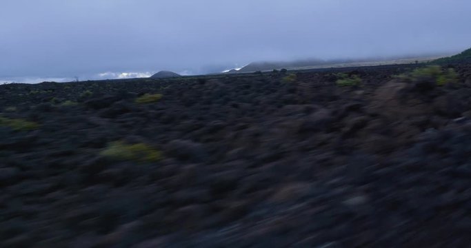 misty Mauna Loa road on the big island of Hawaii gimbal shot facing backwards