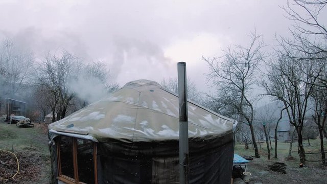smoking yourt in mountains in the snow