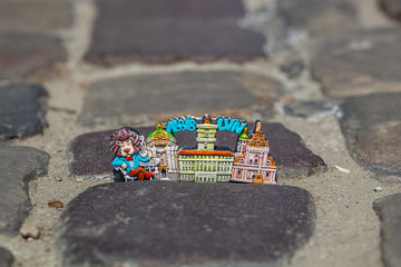 Lviv souvenir magnet on cobblestone pavement