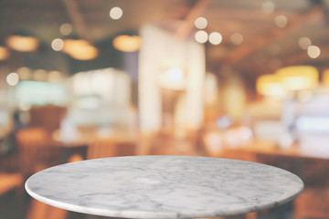 round marble table top with cafe restaurant bokeh lights abstract background for montage product display
