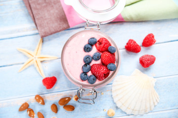 Fototapeta na wymiar Ice cream with berries, raspberry and blueberry in glass jar