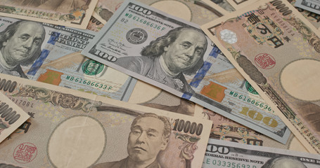 Fototapeta na wymiar Stack of American USD and Japanese Yen