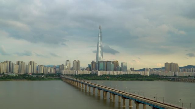 Seoul city top cars train crossing Han river Jamsil railroad  bridge Lotte tower