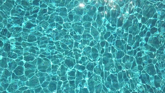 Swimming pool ripples at holiday resort in summer, birds eye view