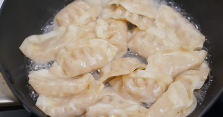 Fry Chinese meat dumpling in skillet pan