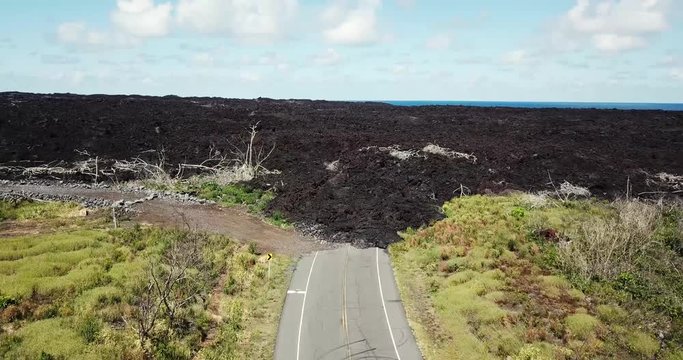 Lava Covers Road from Kilauea Volcano's Puna Eruption in Hawaii Near Issac Hale Beach Park - Aerial View. 4k.