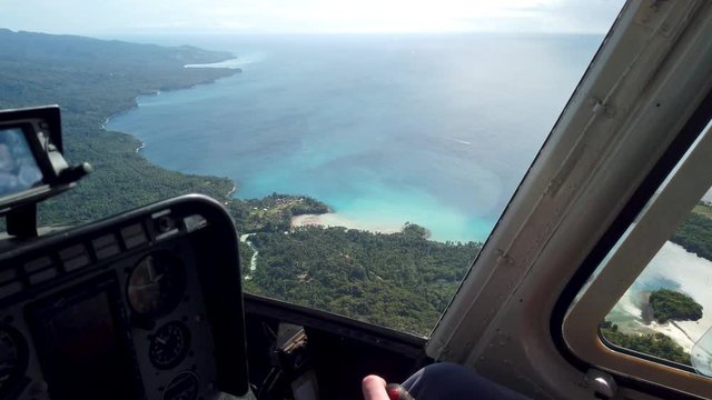 Aerial view tropical coastline from helicopter cockpit, New Guinea