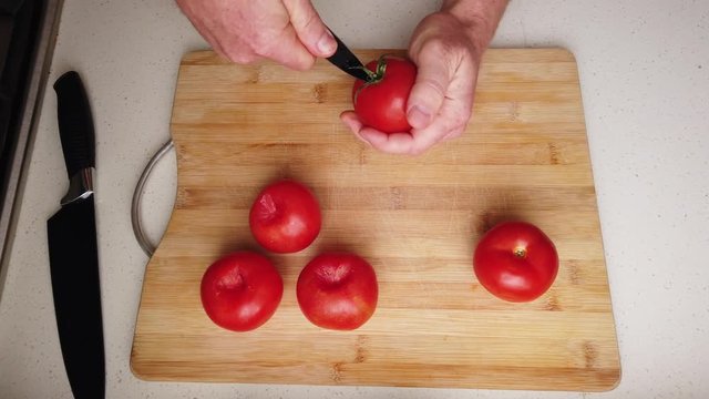 Time lapse of chef preparing to roast tomatoes with balsamic vinegar and garlic