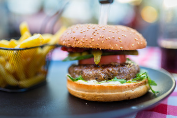 Tasty hamburger with grilled beef and chips on the plate