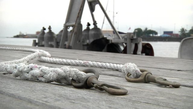 Ropes and Hooks On Wooden Dock Close Up Detail. Tying Up Boat in Honiara Port, Solomon Island