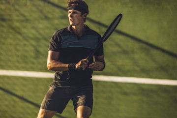 Tennis player practicing tennis on a club court - obrazy, fototapety, plakaty