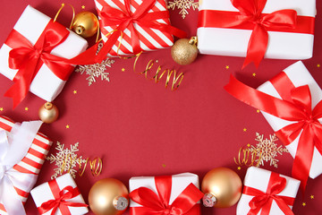 Fototapeta na wymiar Set of beautifully wrapped gift boxes and Christmas decor on a colored background top view. Christmas gifts, Valentine's Day gifts. Holiday, give. Festive background