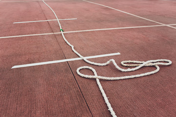 People playing tug of war during obstacle training course in boot camp.