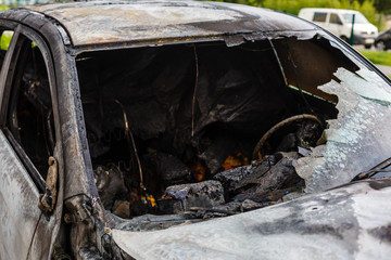 Fototapeta na wymiar Two cars after the fire. Two burned out cars with an open hood. Arson, burnt car