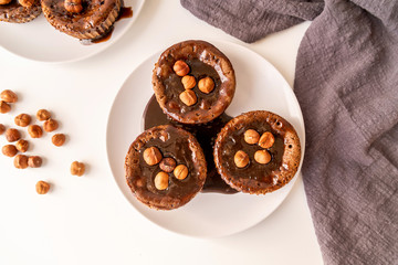 Brownie cupcake with walnut chocolate topping isolated on white
