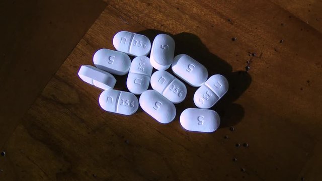 hydrocodone pills on table looking down from above