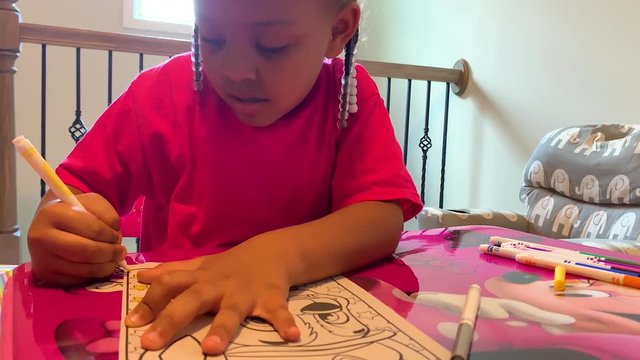 Kid coloring on character with markers