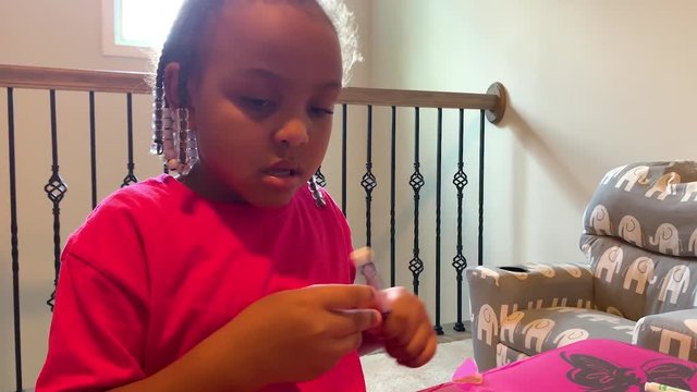 Kid coloring on character with markers