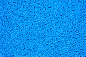 closeup drops water on blue background