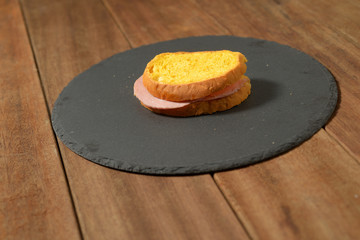 pumpkin flour sandwich with mortadella cooked on the plate