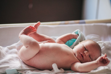 Newborn Lying in a Bed