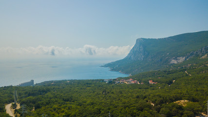 Crimea trip: aerial view of seaside resort city, mountains and curvy roads