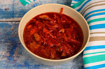 The soup in the plate on the table. Lunch in rustic style.