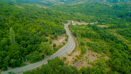 Fototapeta na wymiar Crimean roads: aerial view of curvy mountain road in summer day