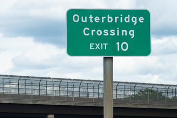 Directional street sign: "Outerbridge Crossing EXIT 10" directing traffic to bridge from New Jersey Turnpike to New York