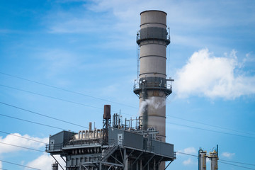 Tall chimney/smokestack/reactor at power plant refining facility 