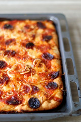 Homemade pizza with tomato sauce, parmesan cheese, pepperoni, chorizo and onion. Selective focus.