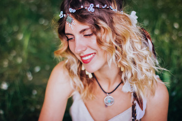 Bohemian hippie girl in white dress. Woman hands with lot of boho style jewelry, blue rings,silver...