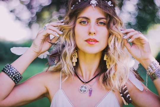 Bohemian hippie girl in white dress. Woman hands with lot of boho style jewelry, blue rings,silver bracelets and henna tattoo. Coachella Fashion Style Idea, outfit .