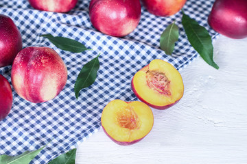 nectarines on the table. background with whole and nectarine halves nectarine closeup.