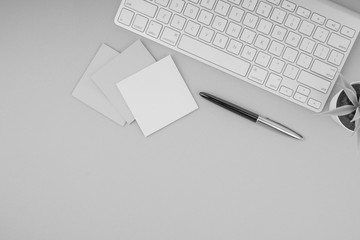 Flat lay, top view office table desk. Workspace with pen, sticky notes, decoration vase and keyboard on Black and White. Business Finance, Education and Copy Space concept