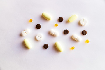 assorted pills and capsules in medicine. drugs of various kinds and different colors. Medicine on white background.Copy space