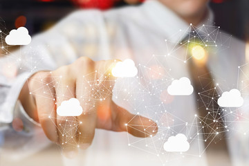 The businessman clicks on the cloud in network .