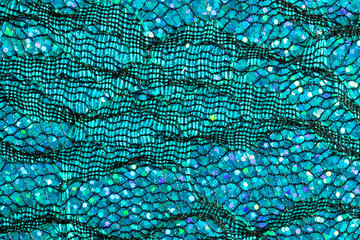 Abstract background of blue lace and sequins to look like the sea or fish scales