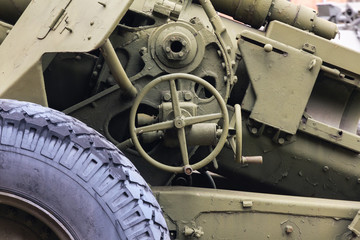 mechanism of artillery guns close-up. Lifting handwheel for aiming and lifting the barrel