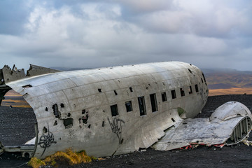Damaged Aircraft on Beach under Dramatic Sky