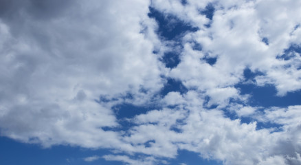 Naklejka na ściany i meble Blue sky with expressive clouds